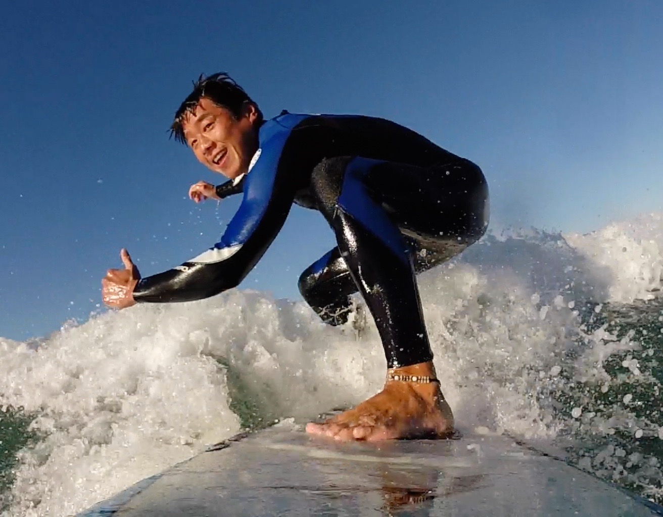 Sam surfing GoPro photo